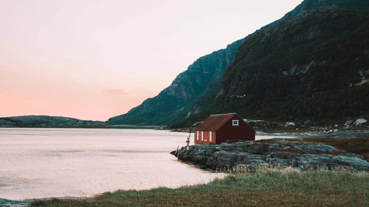 A small house situated in a barren landscape 